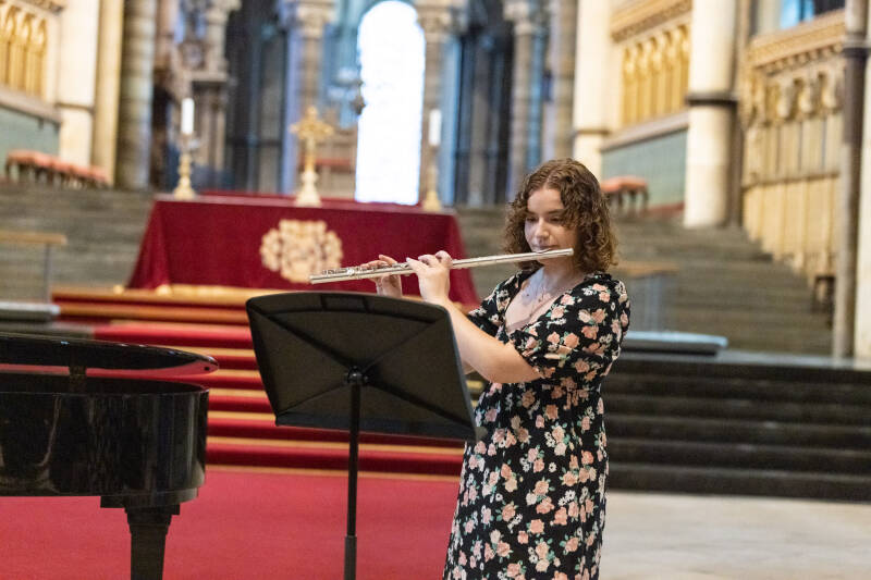Female flautist playing in Canterbury Cathedral