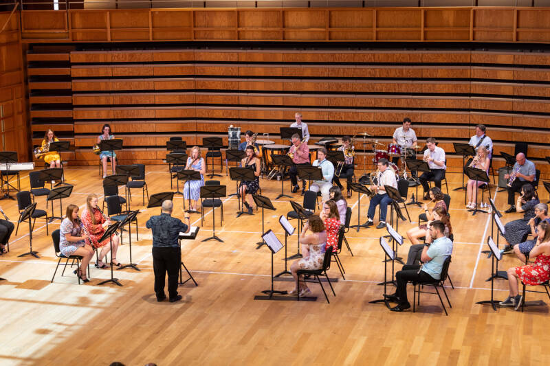 Concert Band wind players performing in a concert-hall