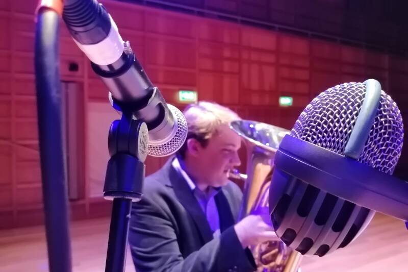 Euphonium player surrounded by microphones in close-up