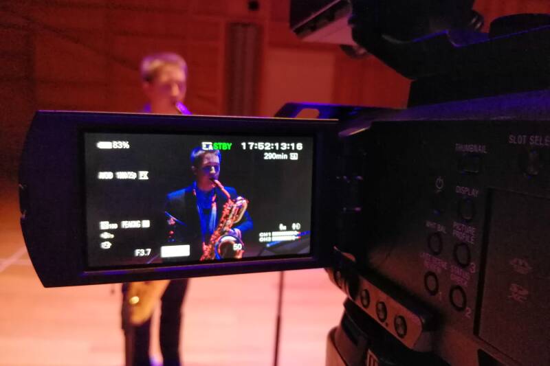 Baritone saxophone player being filmed
