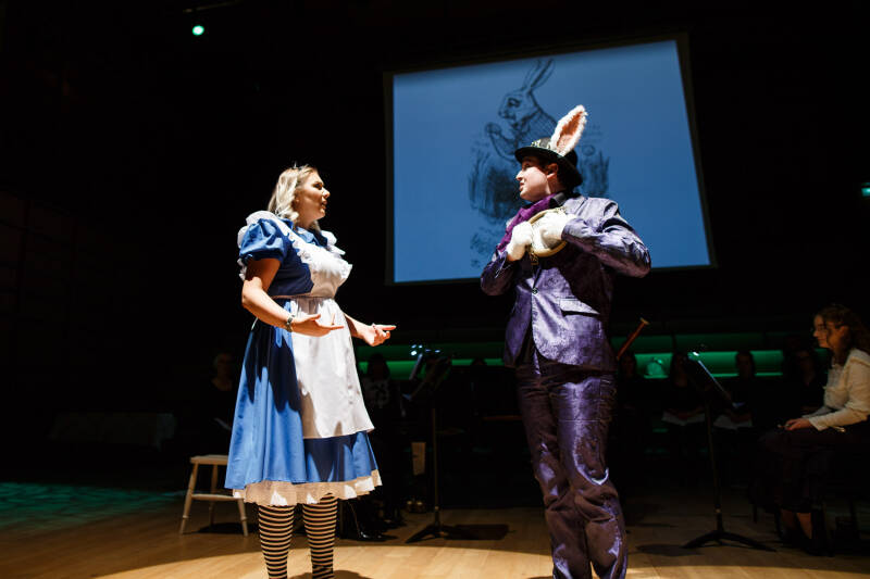 Two performers in costume acting on stage