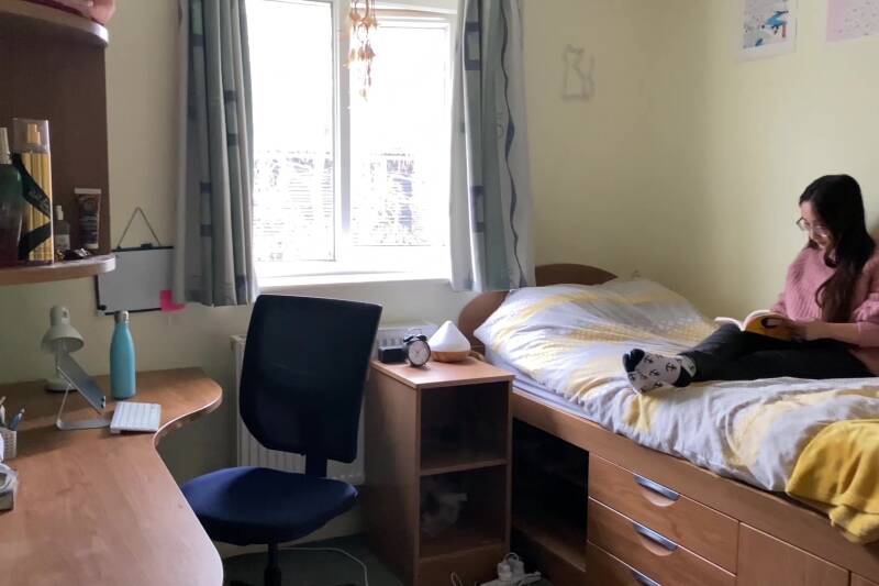 Student sitting on bed in Park Wood House