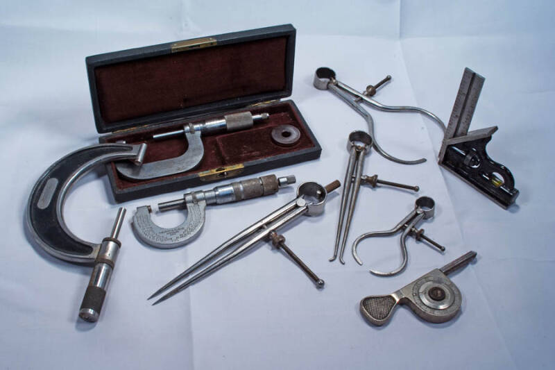 Selectrion of antique measuring devices, including calipers and a sextant