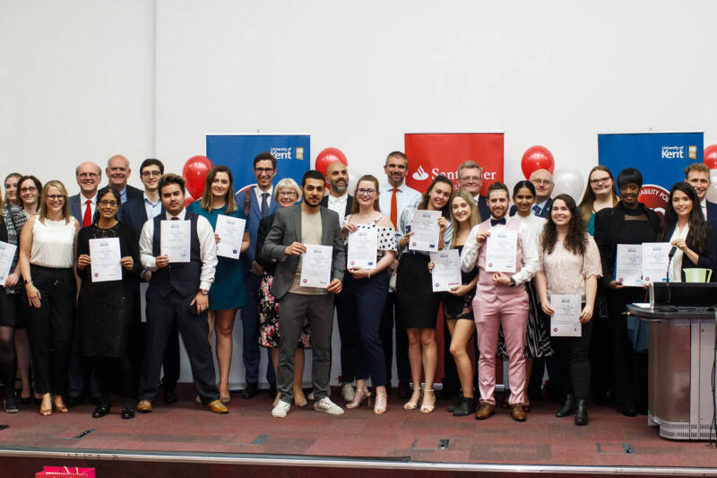 Students and Staff with certificates on stage