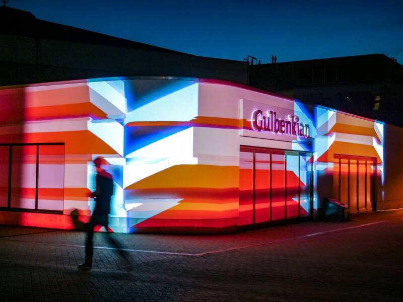 The Gulbenkian Arts Centre lit up by colourful projections