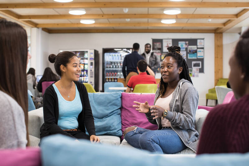 Group of students sitting and talking in a common room