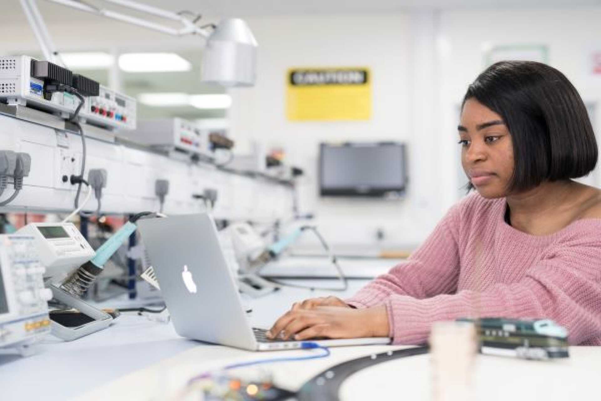 A University of Kent student working at a laptop.