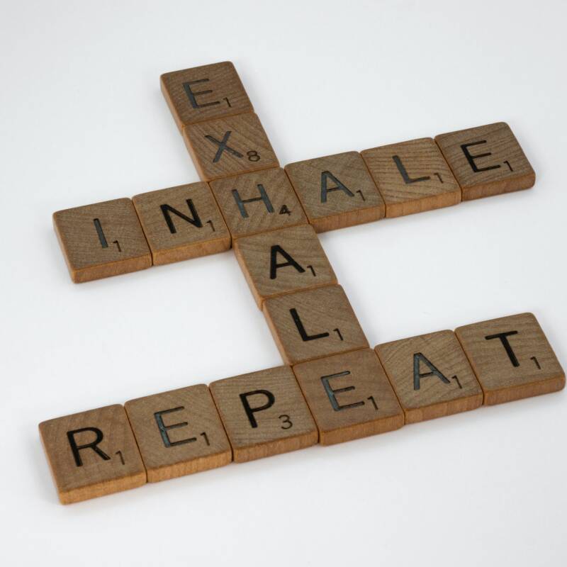 Scrabble tiles reading Exhale, Inhale, Repeat