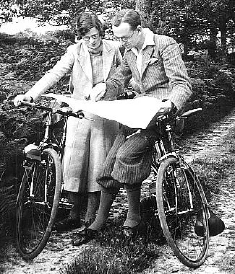 Photograph of Donald and Vera Muggeridge examining a map whilst in the countryside with their bicycles.