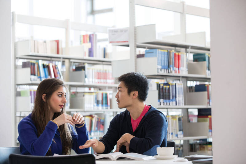 Students talking in the library