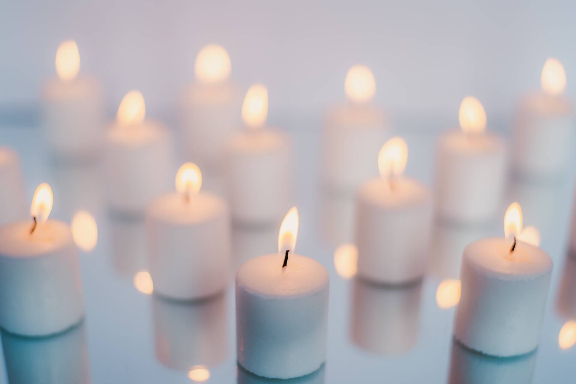 Several small, white candles, all lit.