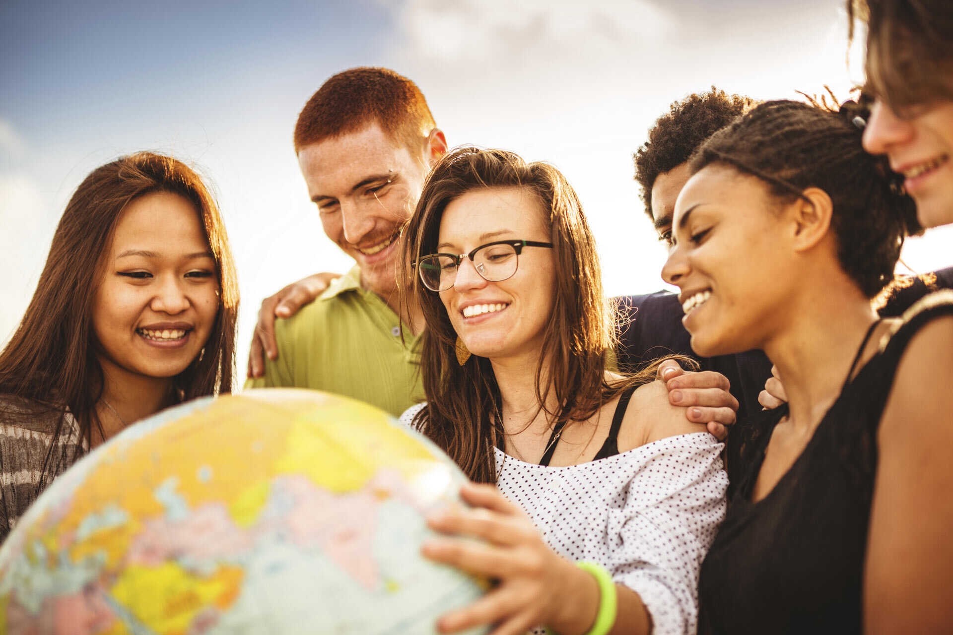 Students looking at a physical globe