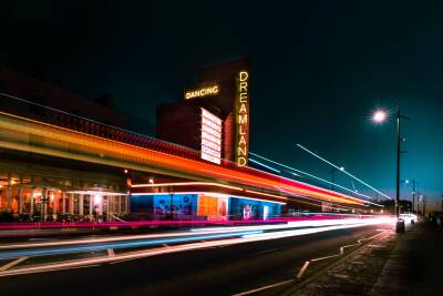 Exterior of Dreamland amusement park lit up at night