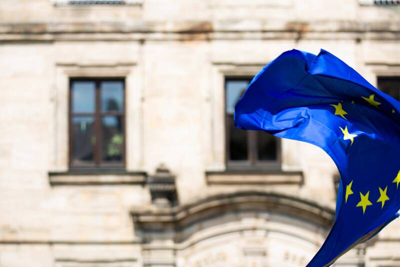 the european flag waving infront of a building