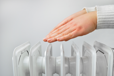 Hands held over radiator