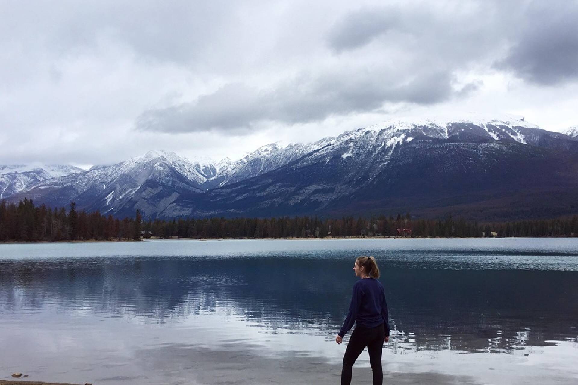 Student Alanah in Canada standing in front of lake and mountains