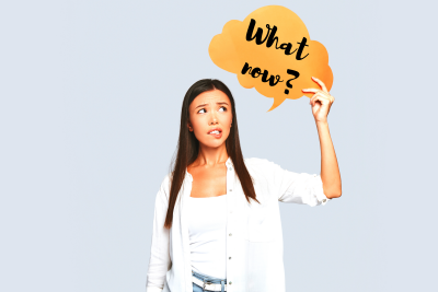 Woman holding speech bubble saying "what now?"