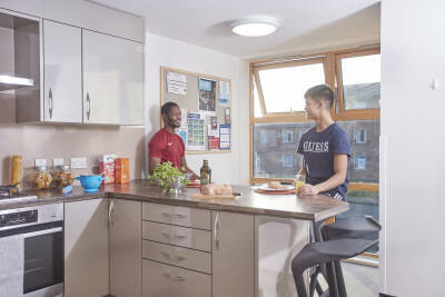 Two students chat in Park Wood flats kitchen