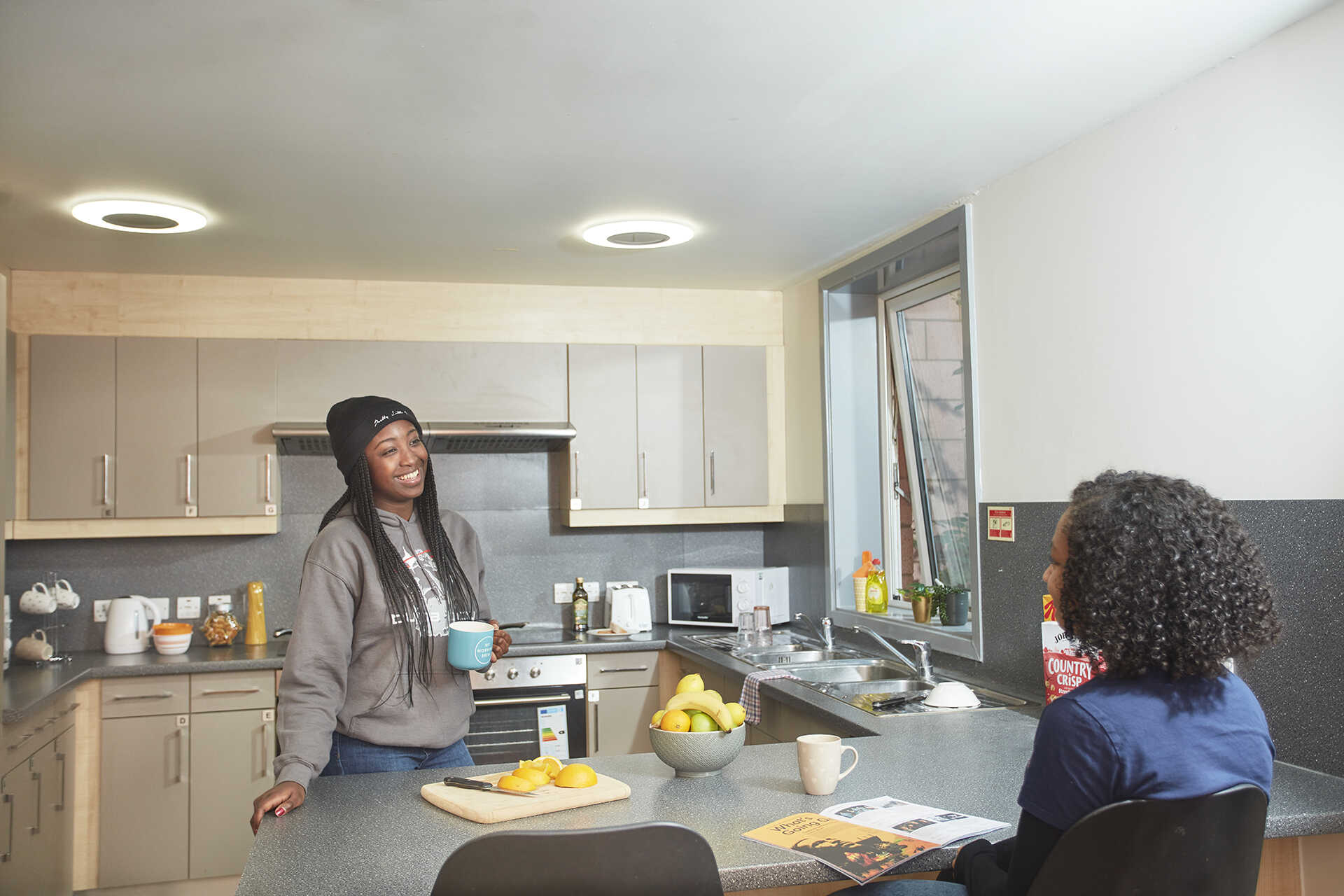 Two female student talking in a Keynes Houses kitchen