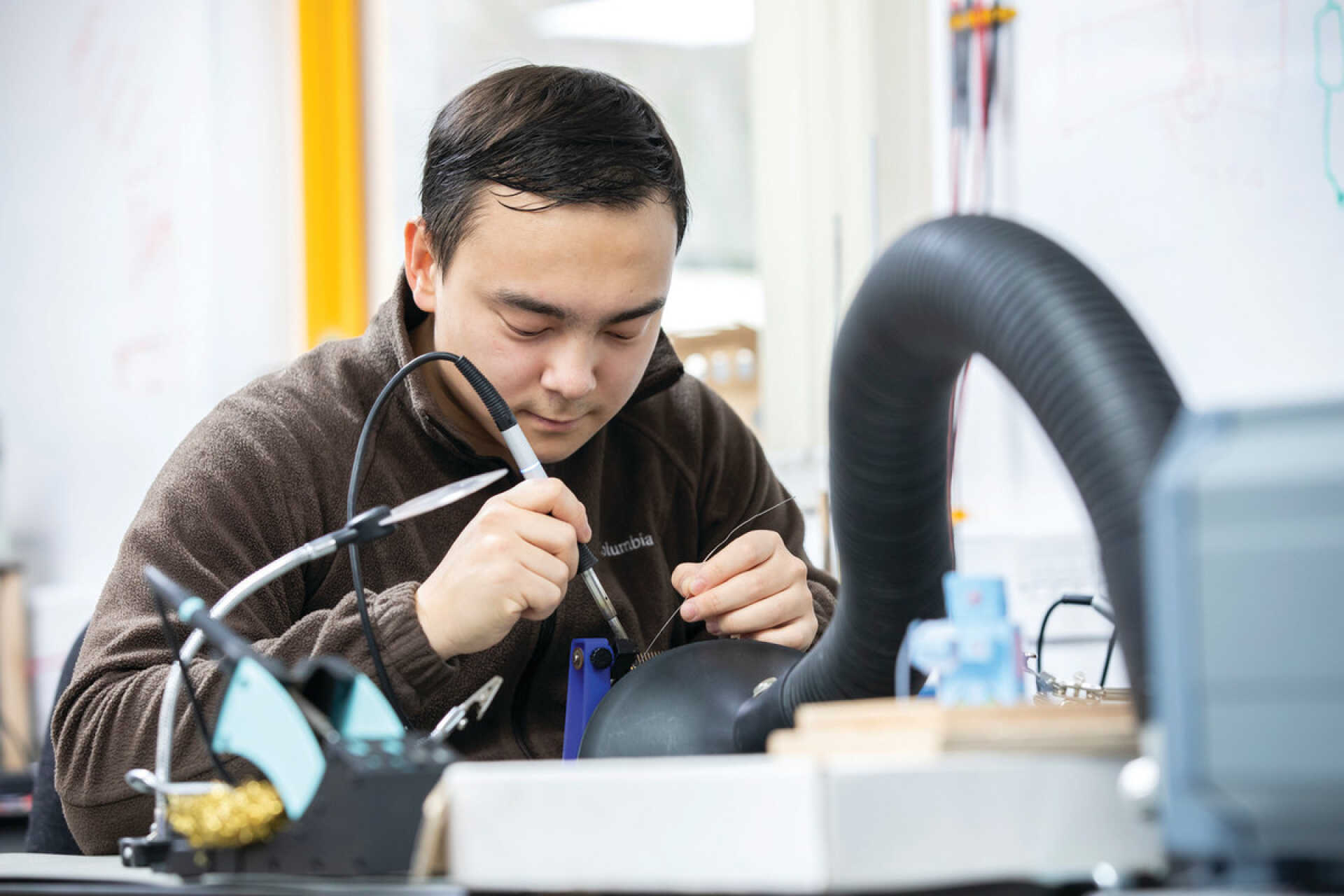 Student using a soldering iron