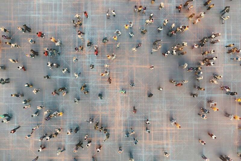 Bird's eye view of people walking around a large open space