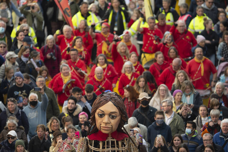 3.5 metre female puppet surround by crowd