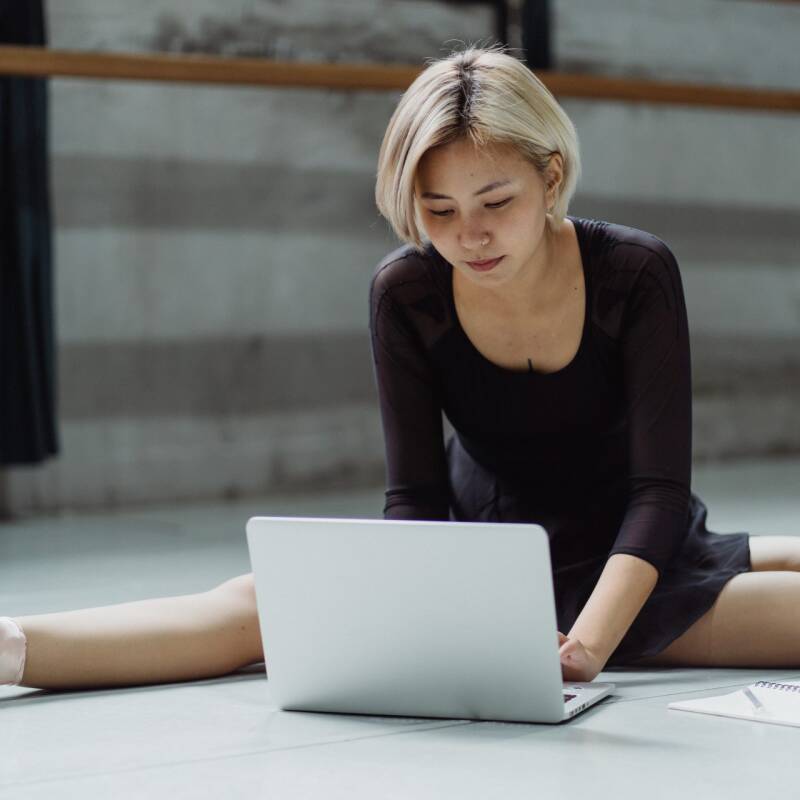 Ballerina using laptop