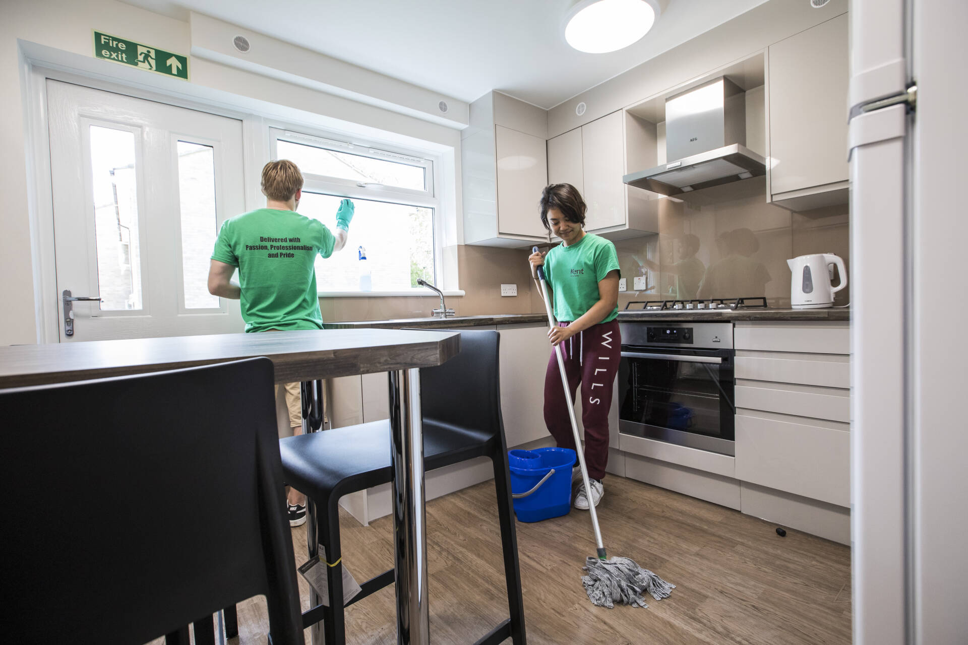Two student casual staff members cleaning a kitchen in Park Wood