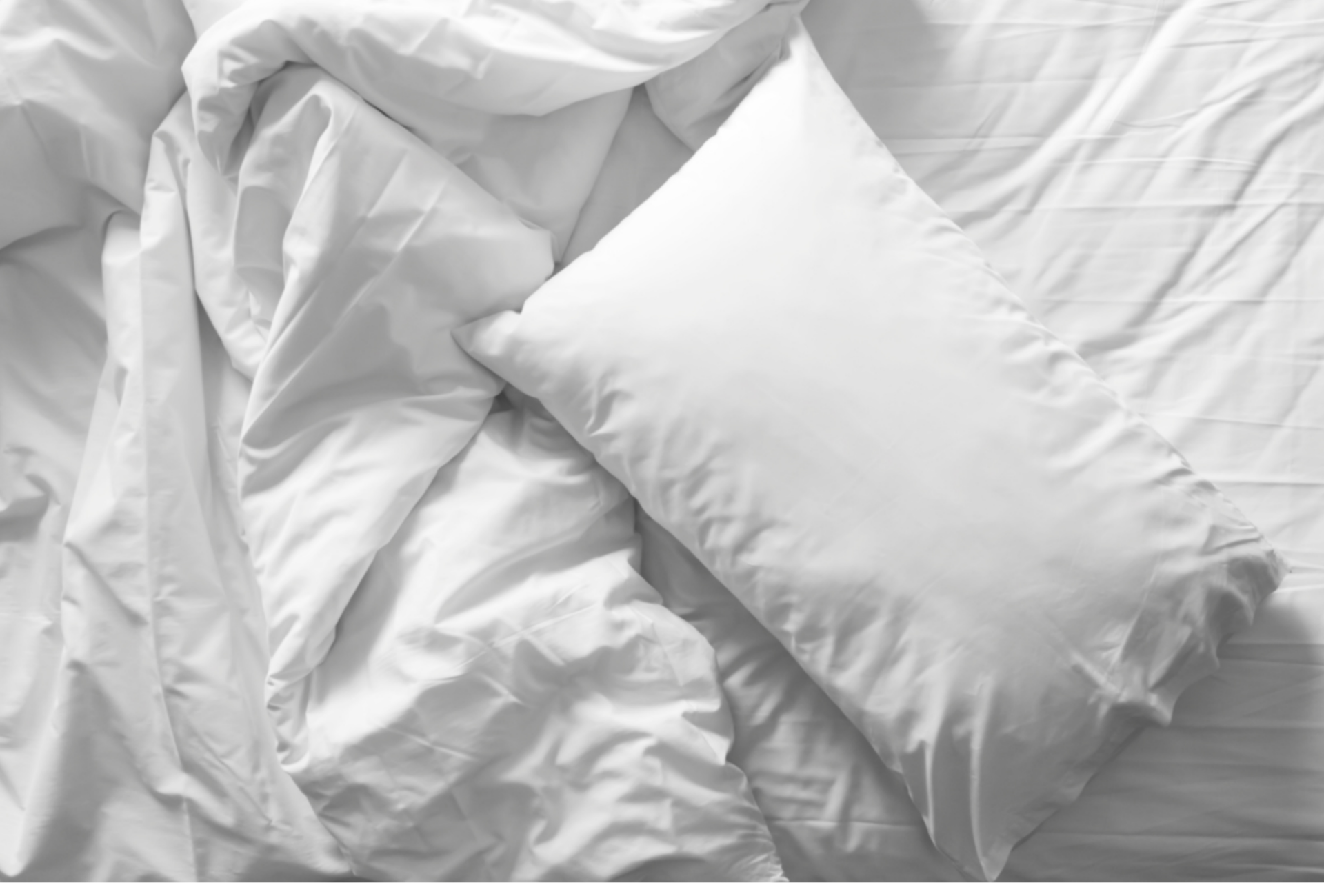 White pillow and sheets on bed