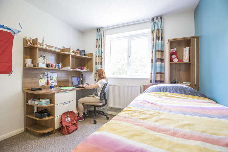 Female student working at a desk in Park Wood House