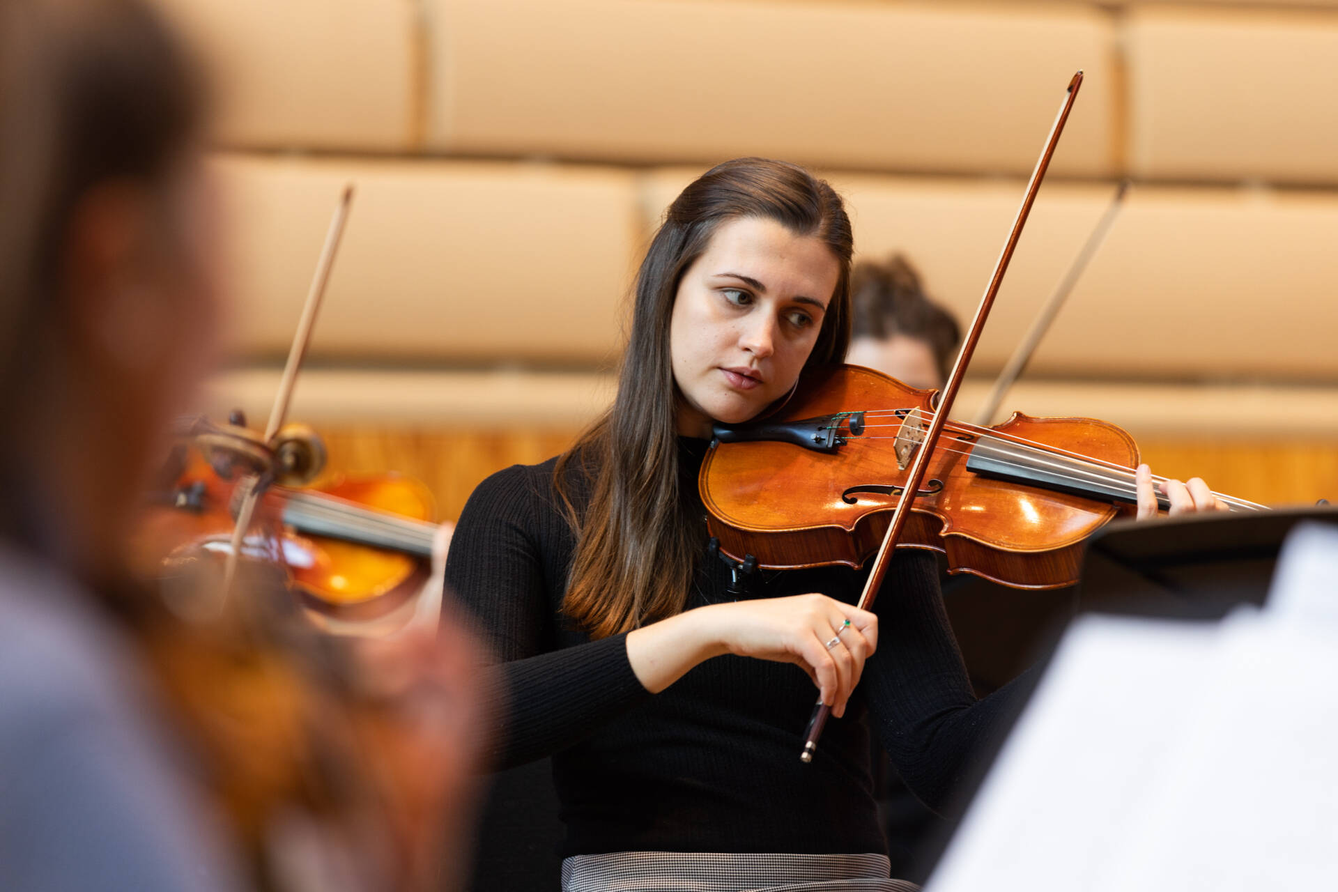 Female string player in rehearsal