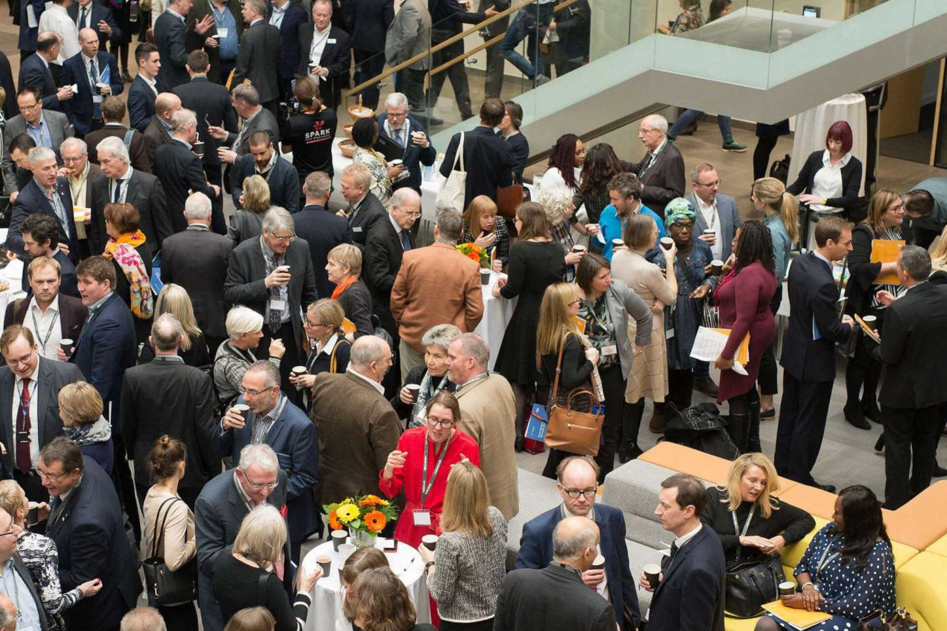 A crowd of people sharing drinks in the Sibson foyer