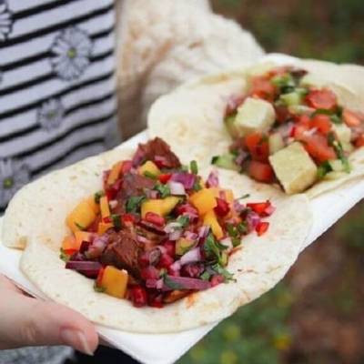 person holding plant based tacos