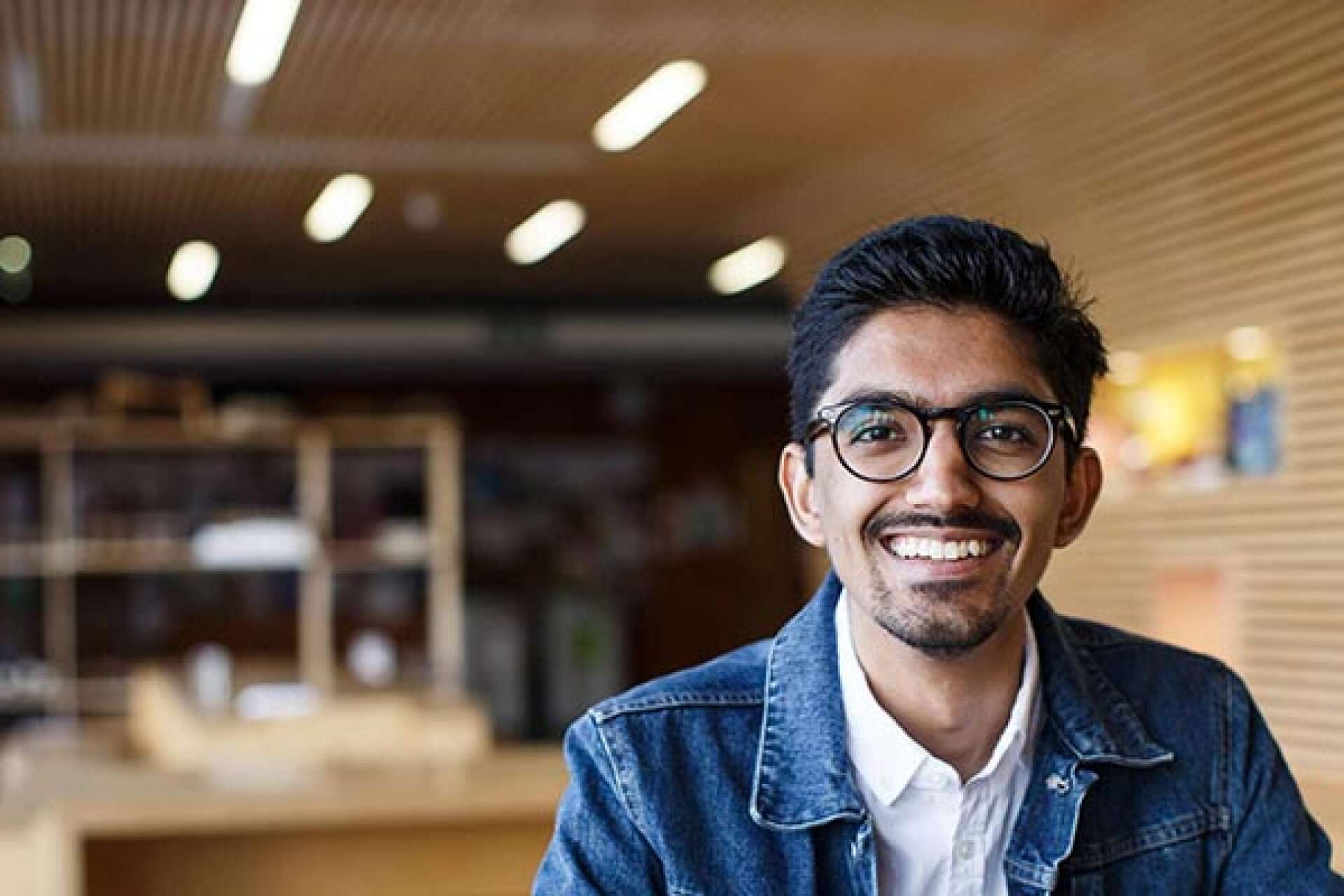 A student smiling into the camera