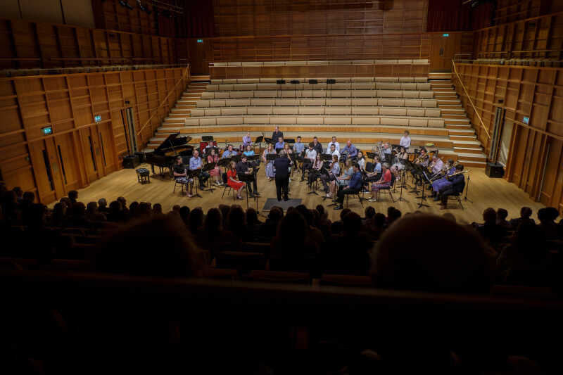 Group of musicians performing in a concert hall