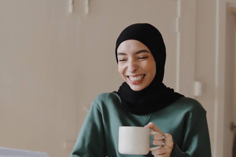 smiling student holding mug