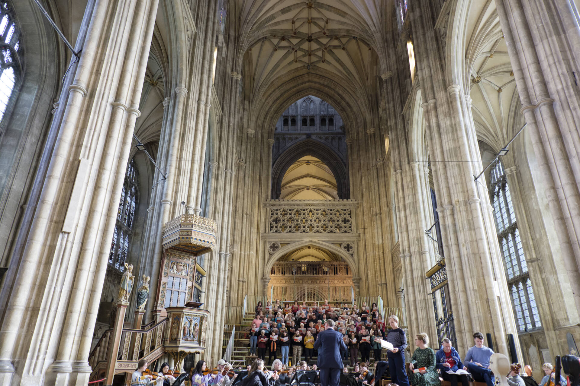 Dramatic shot looking towards a group of orchestral players and singers towards the vaulted Cathedral roof