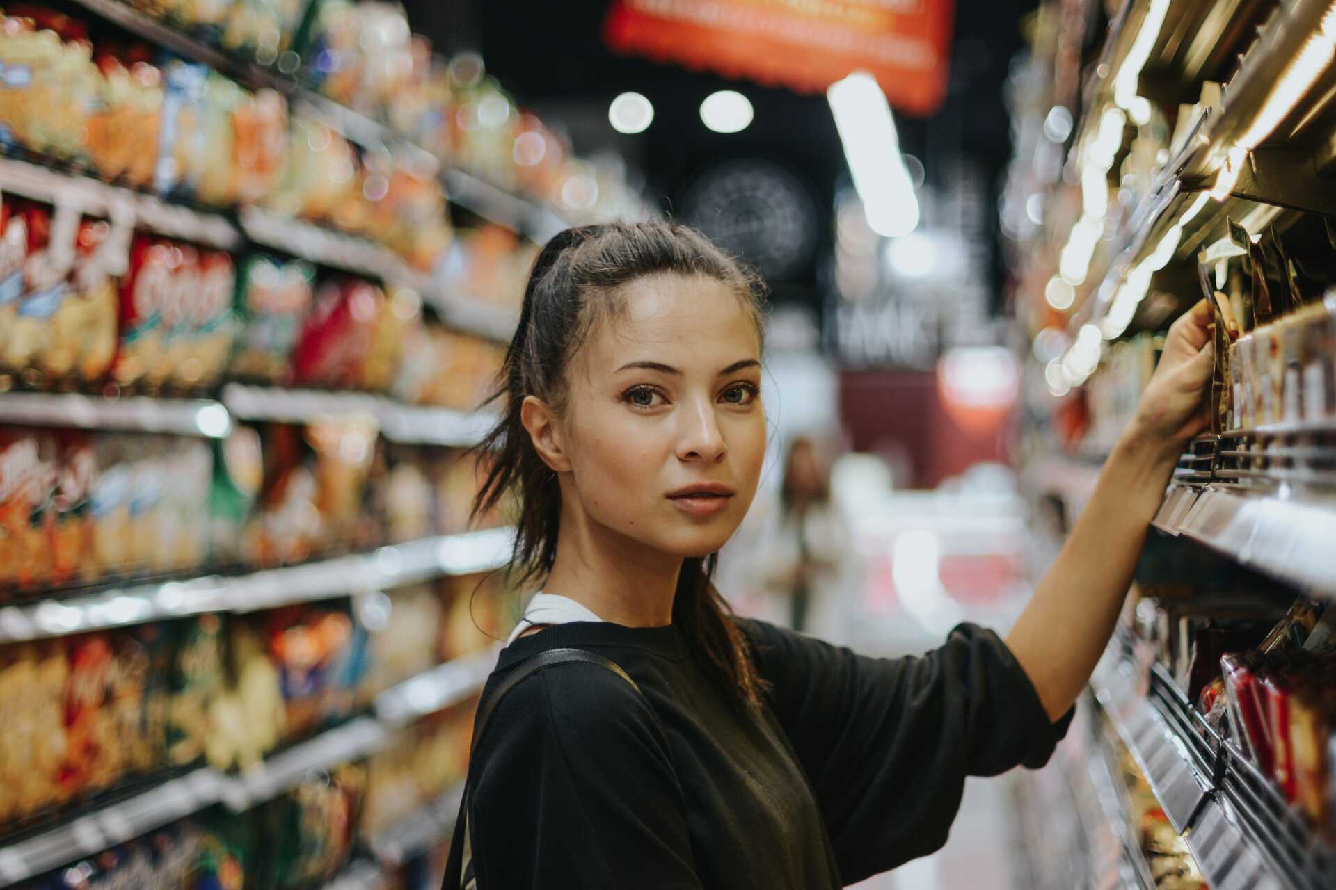 student in shop looking at camera