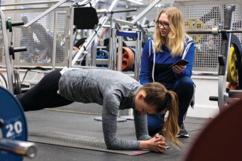Student working with a personal trainer