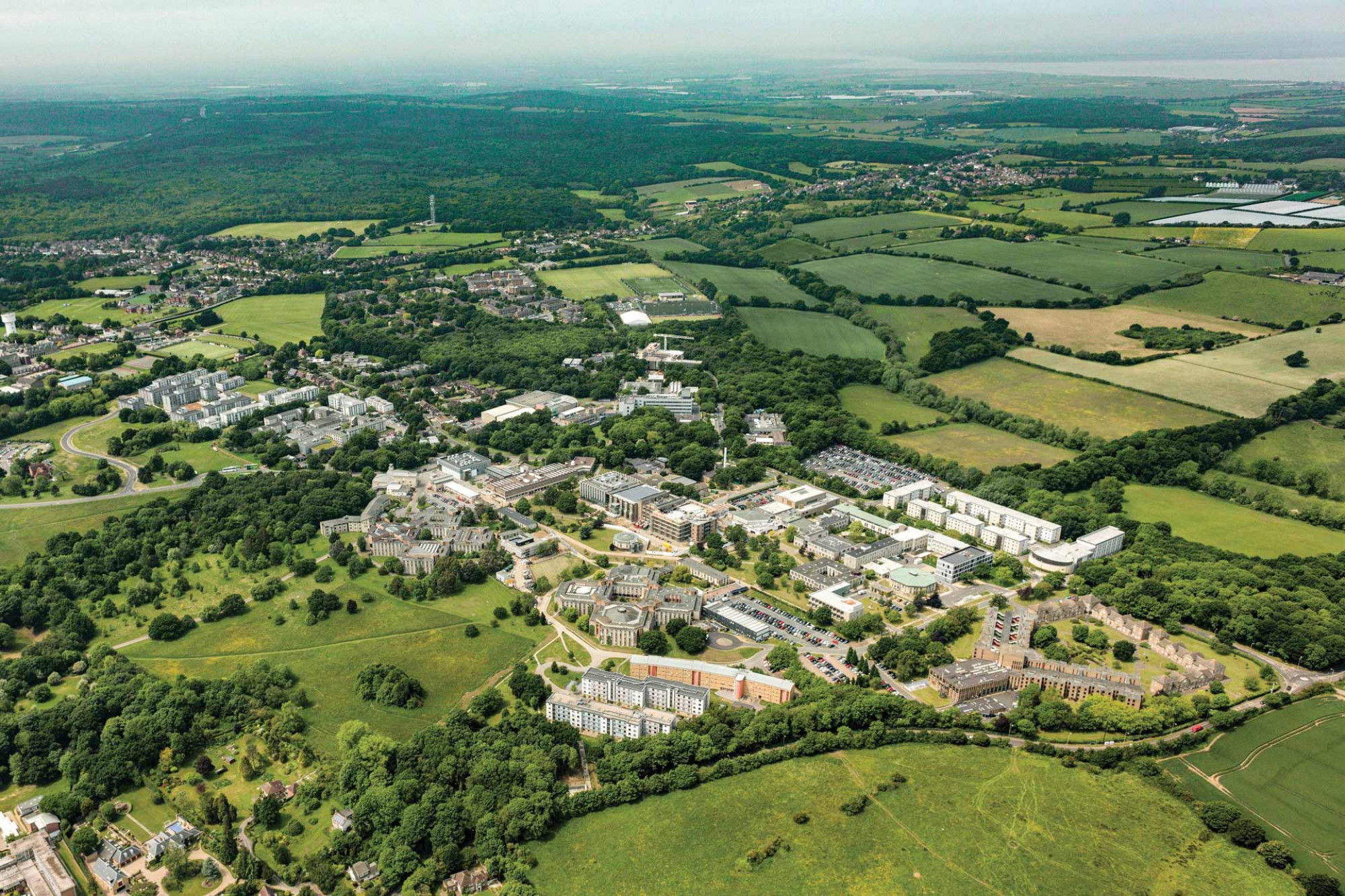 Aerial view of the green Canterbury campus and surrounding area