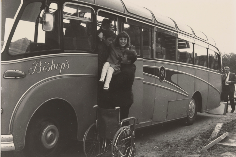 Archive photo. Woman being lifted out of bus into wheelchair.