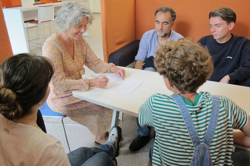 A group of students sitting around a table engaged in conversation