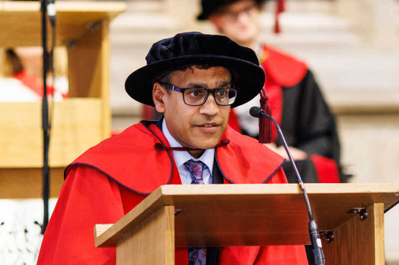 Image of Dr Kush Kanodia, wearing formal dress, speaking during KBS graduation ceremony