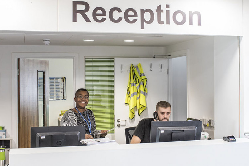 Two receptionist working at front desk