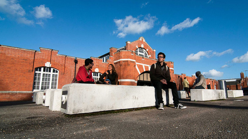 Students sitting outside Drill Hall Library