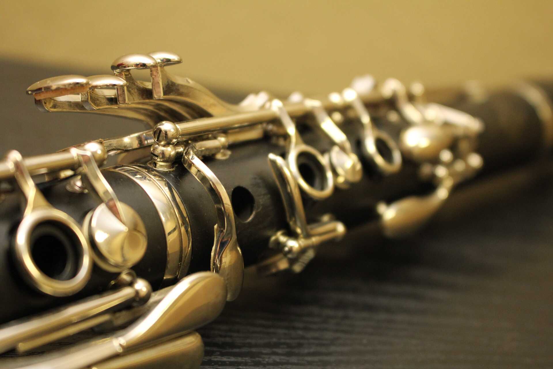 Close-up photo of an oboe lying on its side on a wooden table
