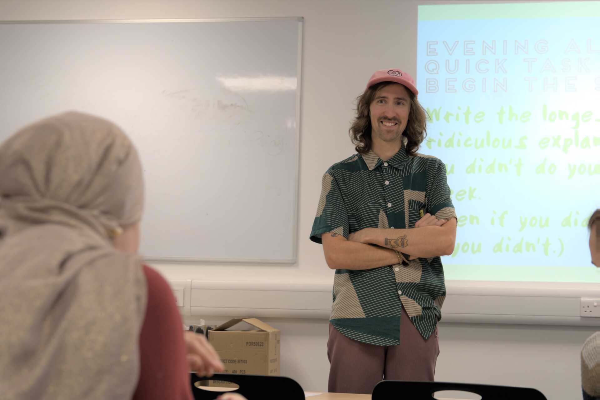 Smiling teacher at front of the class