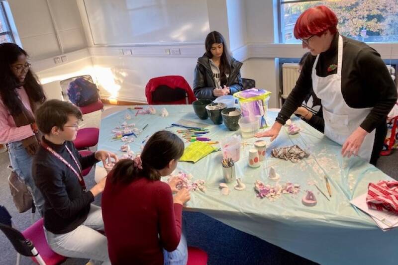 Picture of students taking part in a wellbeing creative workshop including finger casting in December 2022 as part of DHM
