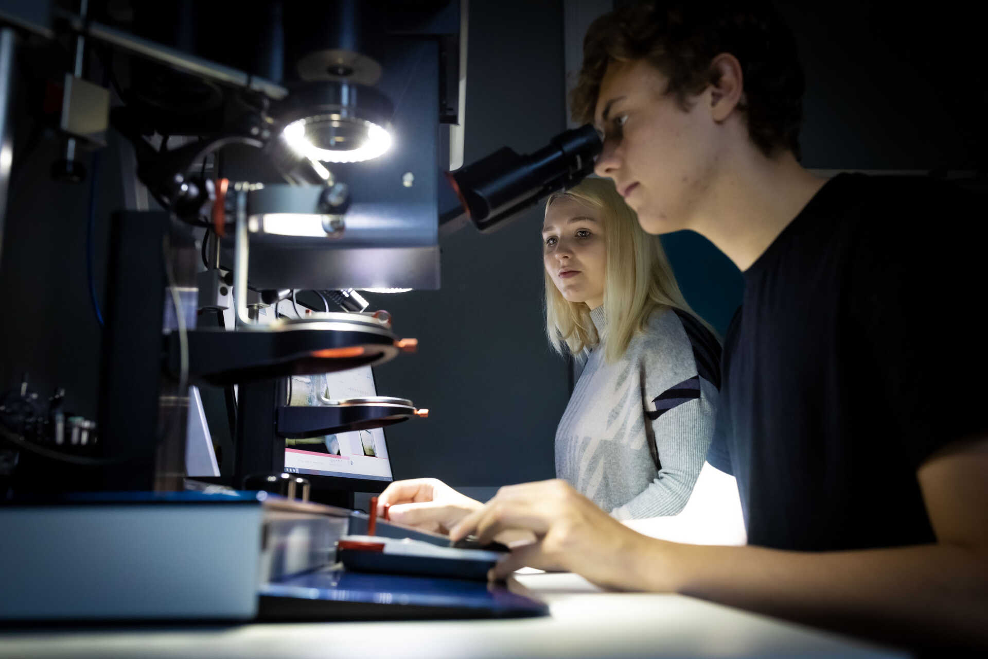 Blue gloves hands analysing chemicals from a vial