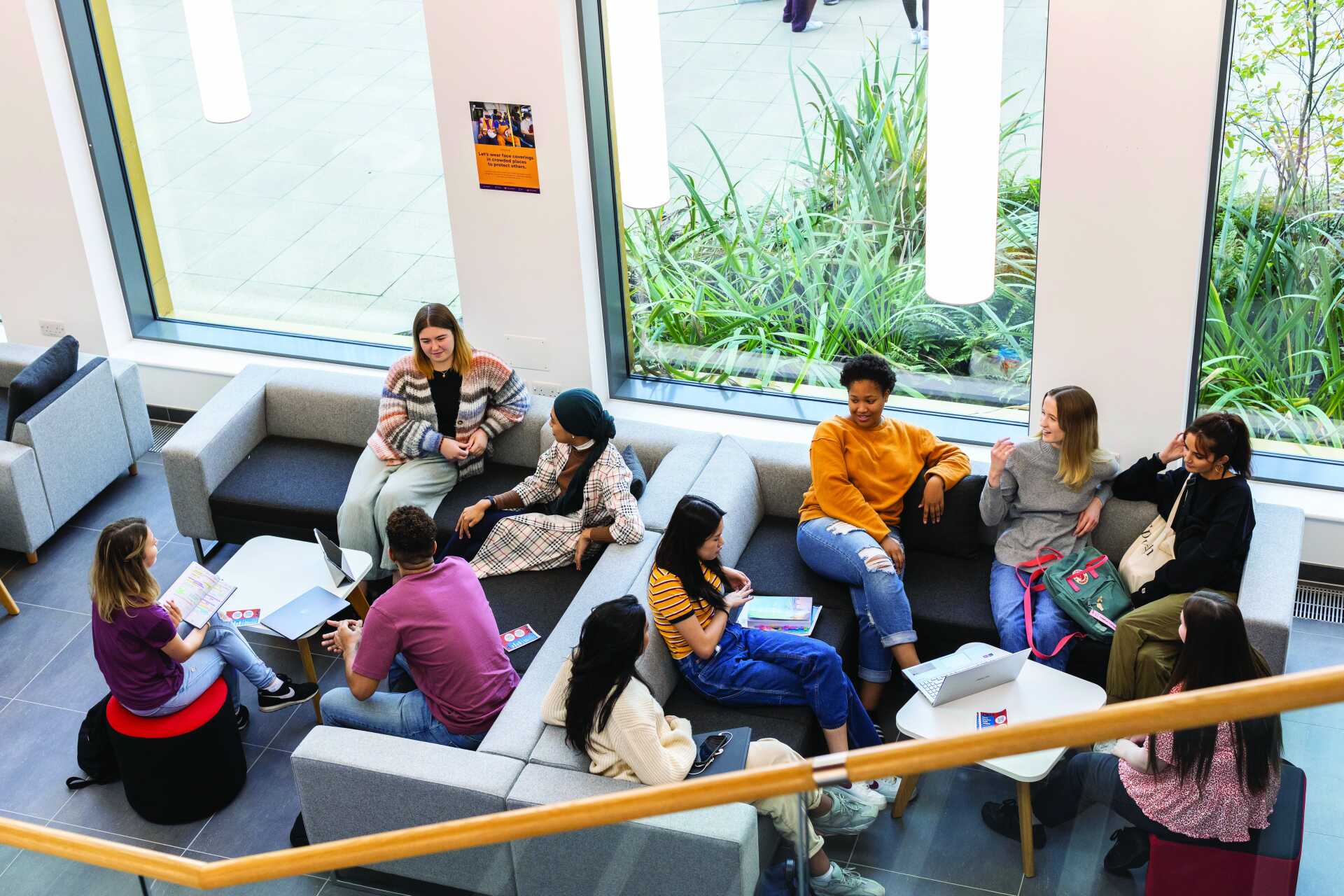 A group of students sitting and chatting in Kennedy lobby